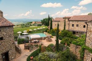an aerial view of a villa with a swimming pool and a yard at Castel Brunello in Montalcino