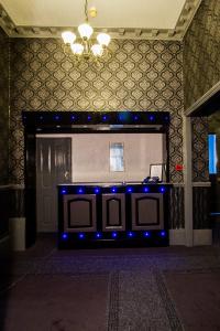 a stage with blue lights in front of a door at The Carlton Hotel in Folkestone