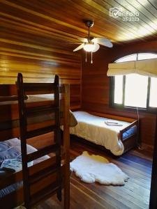 a bedroom with two bunk beds in a cabin at Casa de campo la serena in Minas