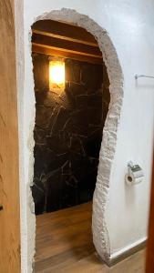 a stone wall with a light in a hallway at El Acicate Hospedaje in Cuetzalán del Progreso