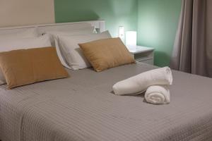 a bed with a white towel on top of it at Adriana Apartment in Agia Marina Nea Kydonias