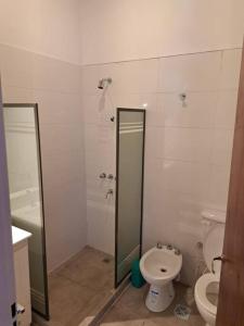 a bathroom with a toilet and a shower stall at Almirante Brown 235 , Dpto 5 in San Martín