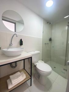 a bathroom with a toilet and a sink and a shower at Ayenda 1224 Pixel House in Medellín