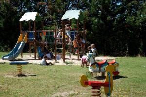 a group of children playing on a playground at Green Village Assisi in Assisi