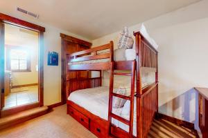 a bedroom with two bunk beds and a mirror at Lodges 1136 in Mammoth Lakes