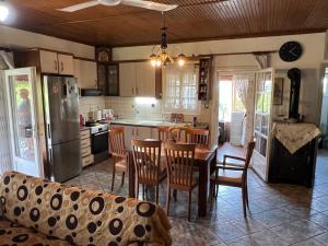 a kitchen with a table and chairs and a refrigerator at Vila Katerina Anna in Nea Kalikratia