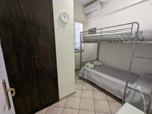 a bedroom with two bunk beds and a door at Villa Valeria in Floridia