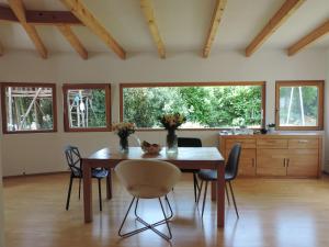 a dining room with a wooden table and chairs at Julia's Mosel Villa Appartement JULIA in Traben-Trarbach