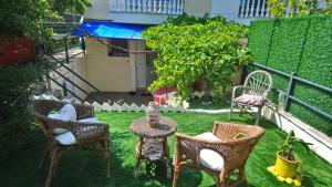 a backyard with chairs and a table and chairs at Christina's House in Iraklitsa