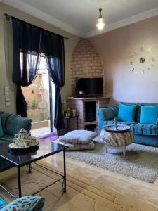 un soggiorno con mobili blu e camino di Dar Lala Fouzia a Taroudant