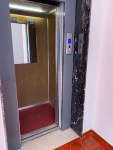 a bathroom with a shower with a glass door at Mondello Sea House in Palermo