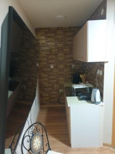 a kitchen with a staircase and a brick wall at Apartma Rešer in Črna na Koroškem