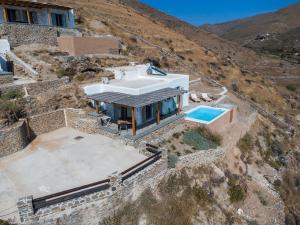 an aerial view of a house on a mountain at Epithea Suites Kythnos 1 με ιδιωτική πισίνα in Kithnos