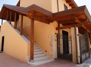 un edificio con escalera y techo de madera en B&B I Greci en Vairano Patenora