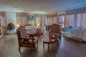 a bedroom with a bed and a laptop on a table at Hotel Royalty in Riobamba