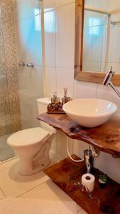 a bathroom with a sink and a toilet at Cabanas Por do Sol in Urubici