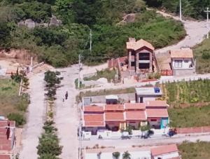 an aerial view of a house in a village at Chalés Recanto das Flores RN in Monte das Gameleiras