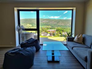 a living room with a couch and a table at Valley House in Notodden