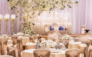 a banquet hall with tables and chairs and a tree at Casa Diora Hotel Jeddah in Jeddah