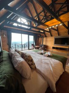 a large bed in a room with a large window at Defne Bungalow Yomra in Yomra +52 photos