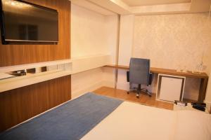 Postel nebo postele na pokoji v ubytování Itaimbé Palace Hotel