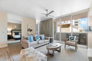 a living room with a couch and a table at Palm Beach Singer Island Resort & Spa Luxury Suites in Riviera Beach +271 photos