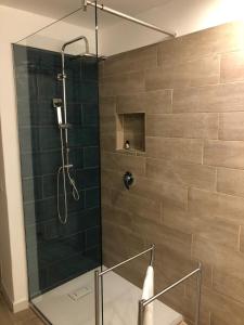 a shower with a glass door in a bathroom at Kalé Atenea in Agrigento