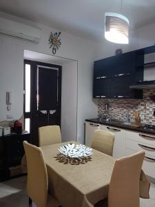 a kitchen with a table with chairs and a dining room at Delilah's house in Catania