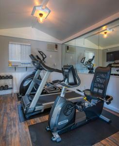 a gym with two exercise bikes and a treadmill at The Tavern Hotel in Cottonwood