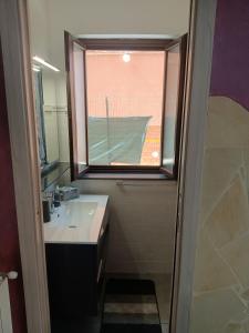 a bathroom with a sink and a window at Delilah's house in Catania