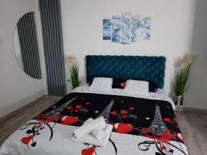 a bedroom with a bed with a blue headboard at Apartman u centru 1 in Šid