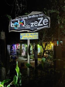 a sign for a restaurant at night at Guest House Boki da Zezé in Marau