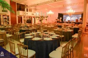 a banquet hall with tables and chairs and chandeliers at Itaimbé Palace Hotel in Santa Maria