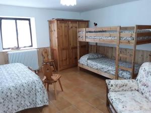 um quarto com 2 beliches e uma cama em Tana della volpe 2 em Gressan