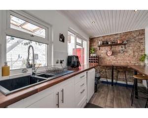a kitchen with a sink and a counter at Central Belfast Apartments Ballyhackamore in Belfast