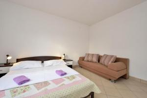 a bedroom with a bed and a couch at Holiday home in Drage with sea views, balcony, air conditioning,WiFi 592-1 in Drage +47 photos