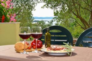 a table with two glasses of wine and a plate of food at Holiday home in Drage with sea views, balcony, air conditioning,WiFi 592-1 in Drage