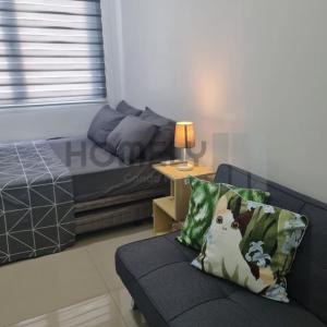 a living room with a couch and a bed at Homely - SMDC Green 2 Residences, Dasmarinas City in Pasong Bayog