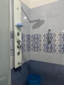 a bathroom with a blue toilet and a wall at Serenity Villa and Treehouse in Palakkad