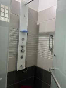 a small bathroom with a shower with a toilet at Serenity Villa and Treehouse in Palakkad