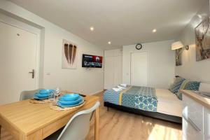 una camera con letto e tavolo con piatti blu di M4 Coeur Massy RER BC 600m - Orly20 min a Massy
