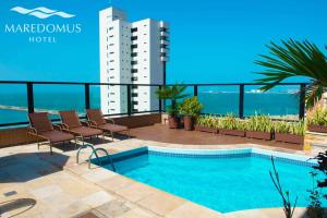 a swimming pool on the roof of a building at Maredomus Hotel in Fortaleza