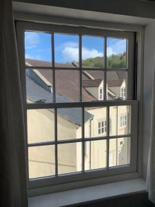 a window with a view of a building at Modern loft retreat in the heart of Nailsworth in Nailsworth