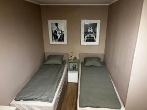 two beds in a small room with two beds sidx sidx sidx at Jourek Apartment in Varaždin