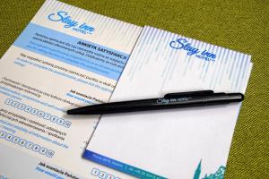 a black pen sitting on top of a visa card at Stay inn Hotel Gdańsk in Gdańsk