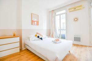 a white bedroom with a bed and a window at Le Rome - Grand 3 ch 6 pers proche Vieux-Port in Marseille