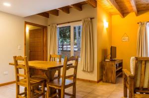 拉安戈斯圖拉鎮的住宿－BOG Apart Foresta - A minutos del cerro bayo，一间带木桌和椅子的用餐室