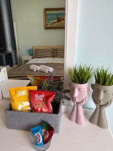a table with two vases and a box of snacks at Guest house “Poli” in Nesebar +47 photos