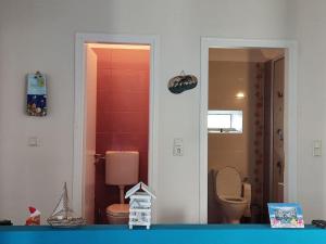 a view of a bathroom with a toilet and a mirror at Korina's house in Loutsa