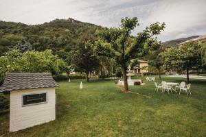 a small shed in a yard with a table and chairs at Hotel Catalunya Park in Ribes de Freser